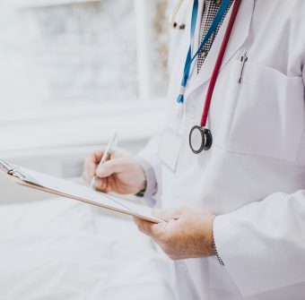 Physician noting down symptoms of a patient